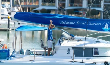 Man steering Brisbane Yacht Charters Moreton Bay