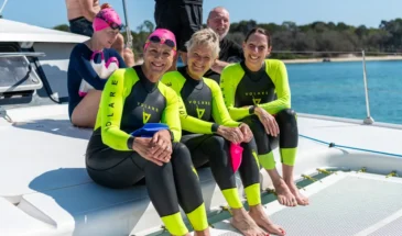 Group of swimmers in wetsuits on a boat at Moreton Bay.
