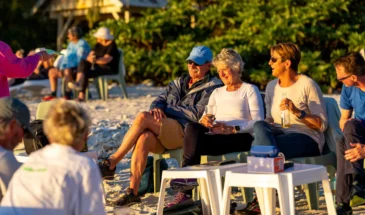 People relaxing on the beach at sunset on Lady Elliot Island.